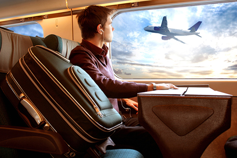 web_man-on-train-watching-plane_credit_Ollyy_shutterstock_10665658.jpg